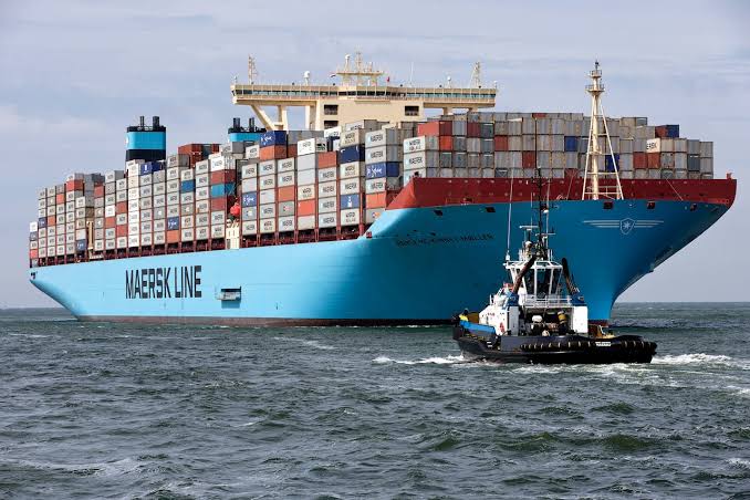 Container vessel under tow, loaded with shipping containers