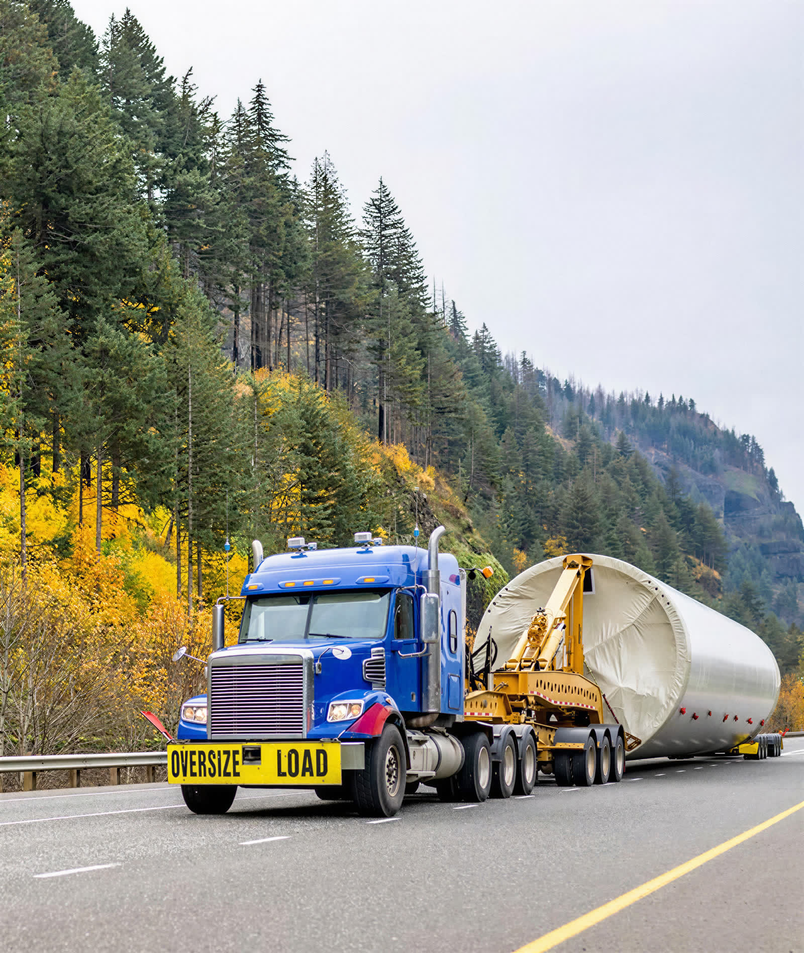 Tractor unit hauling an oversized industrial section on a multi-axle trailer