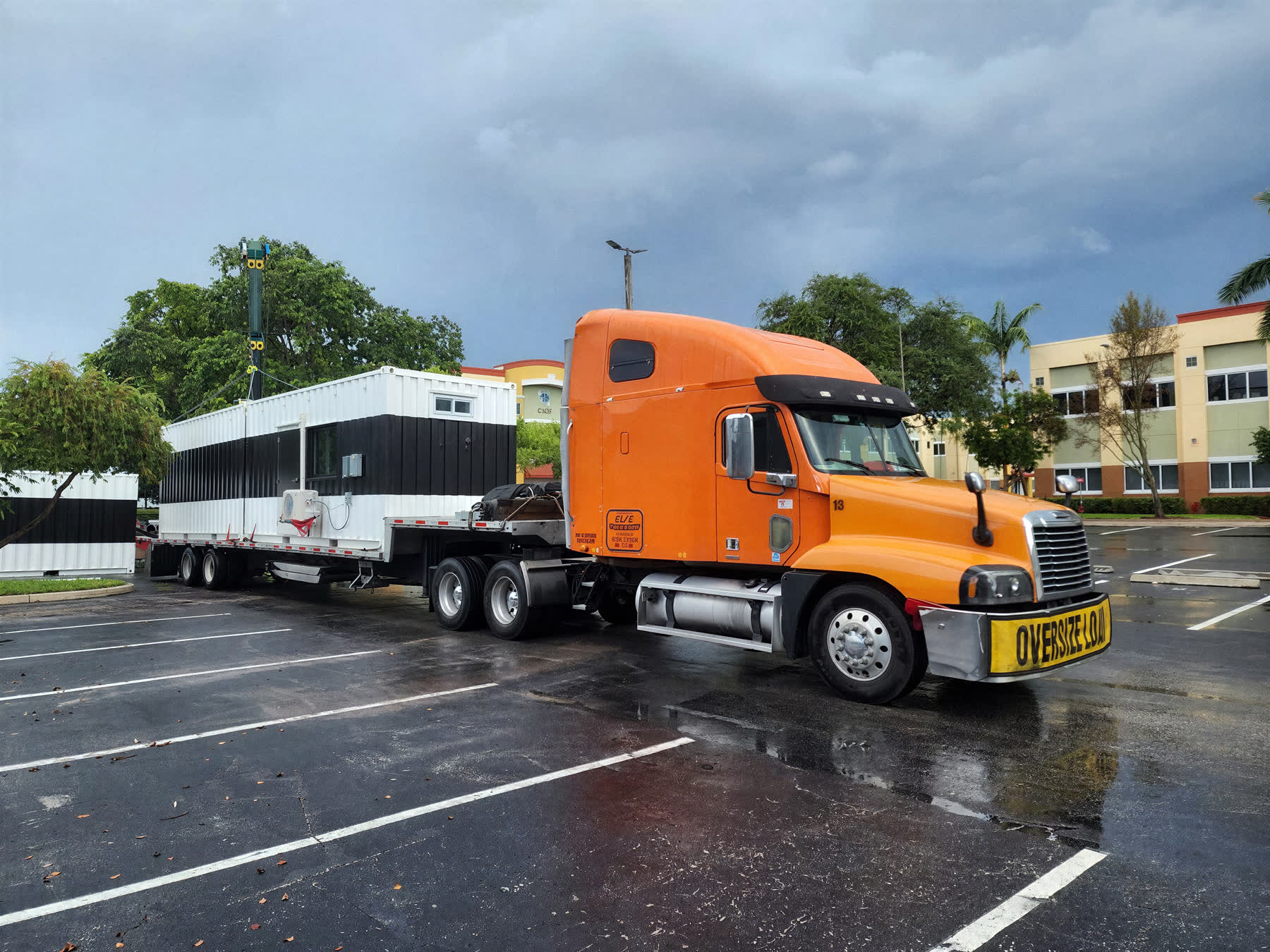 Tractor unit with an oversize load secured on a step-deck trailer